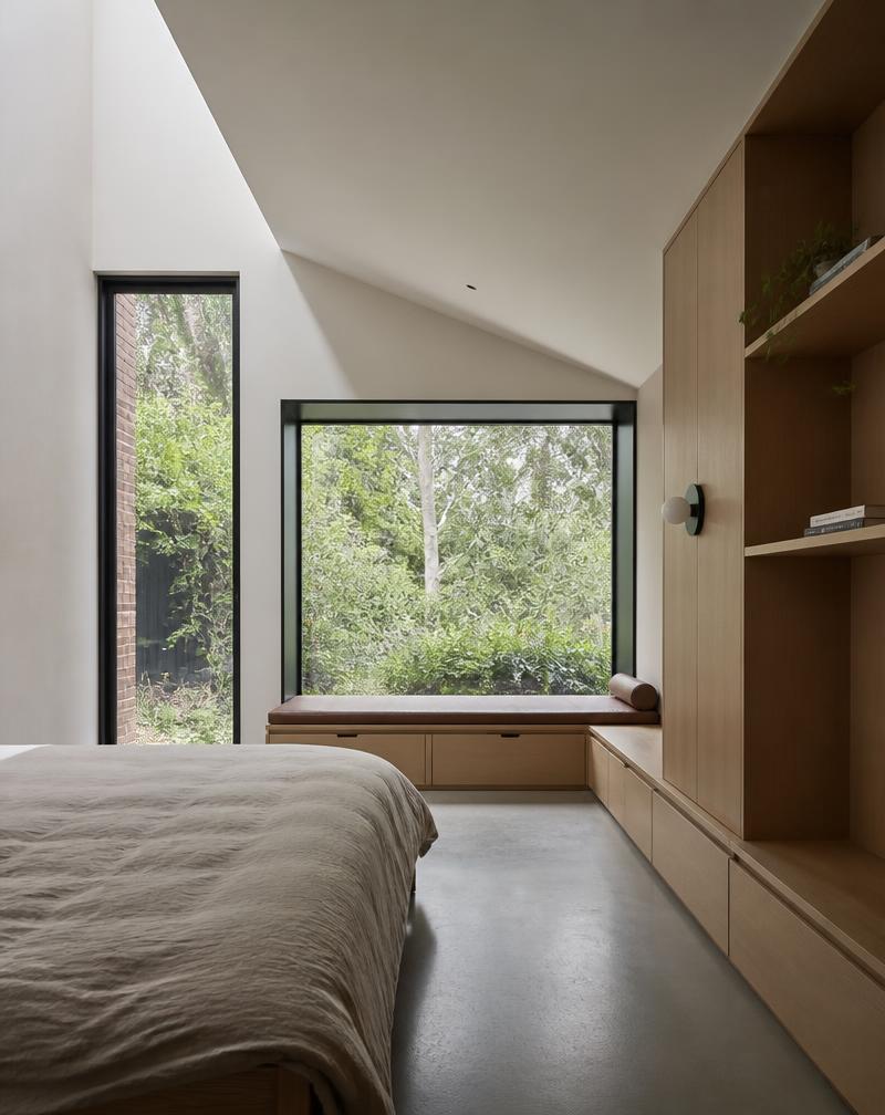Minimalist bedroom extension with large windows and custom carpentry